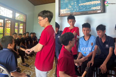 CodeComplete team member engaging with children during an English activity at SOS Village, spreading learning and care.